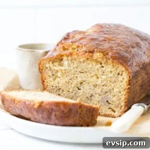 20 Sourdough Discard Recipes Perfect for Freezing 18 A loaf of sourdough discard banana bread sliced open to show inside texture.