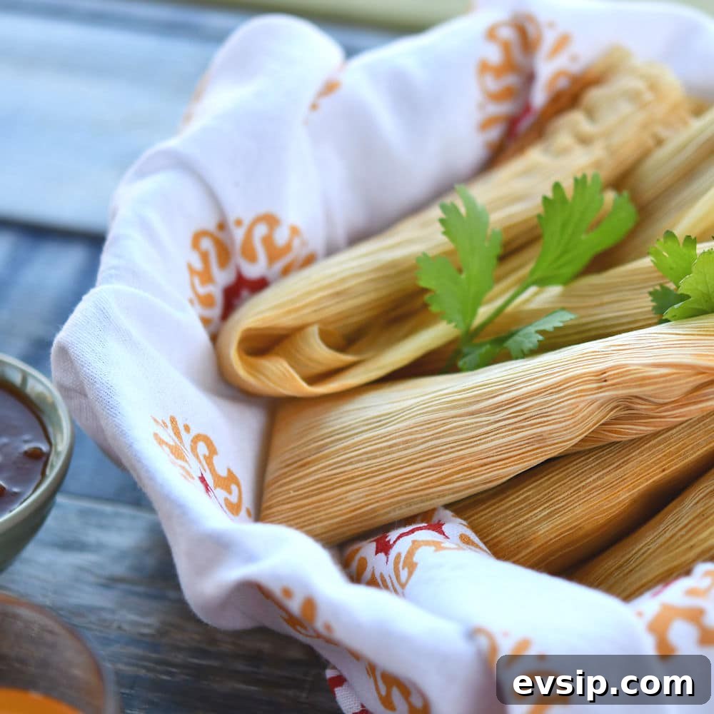 A basket of freshly made pork tamales, still in the husk