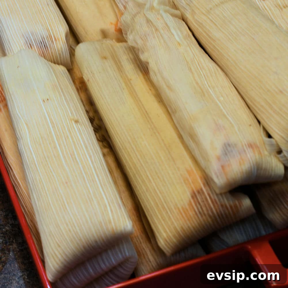 take the tamales out of the steamer and place in a large tray to cool