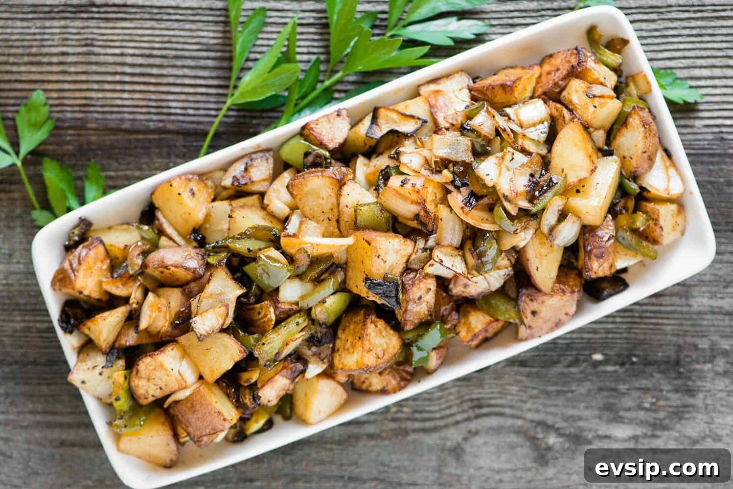 A plate of breakfast potatoes on a table