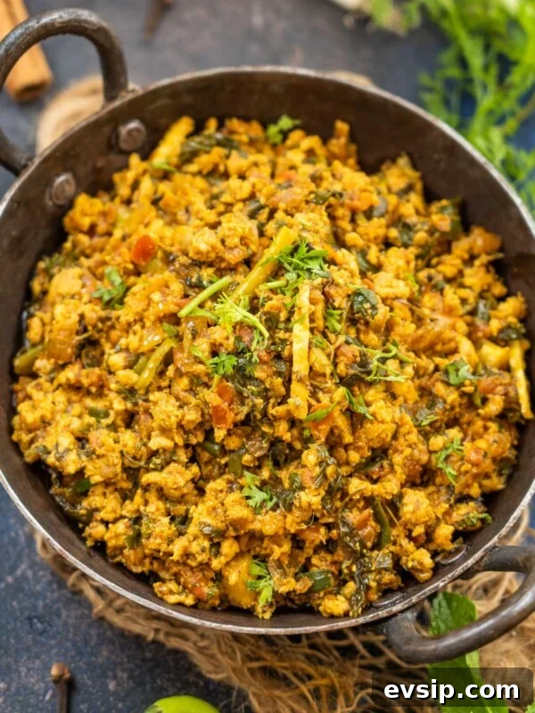 A black bowl filled with spicy Chicken Keema Masala curry.