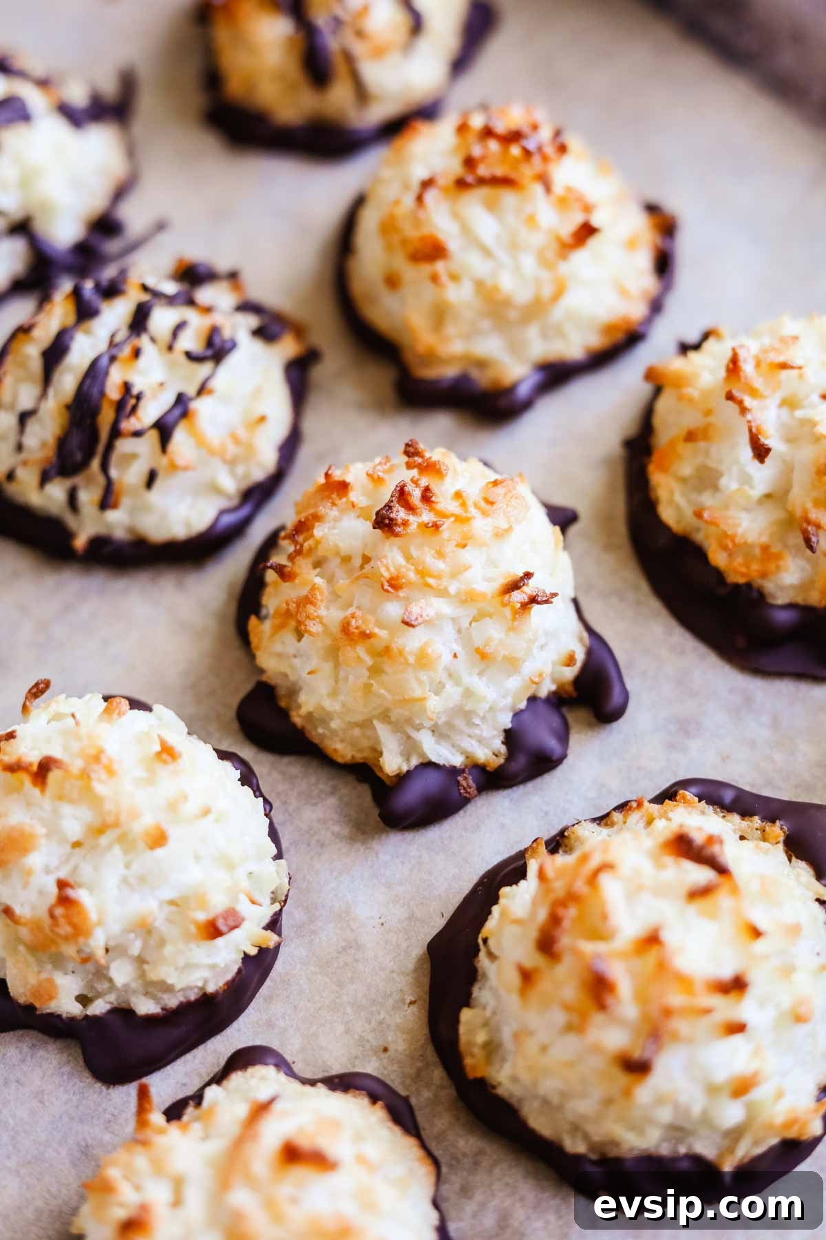 Chewy Gluten-Free Coconut Macaroons Recipe 2 Gluten-free coconut macaroons drizzled and dipped in chocolate on a sheet pan.