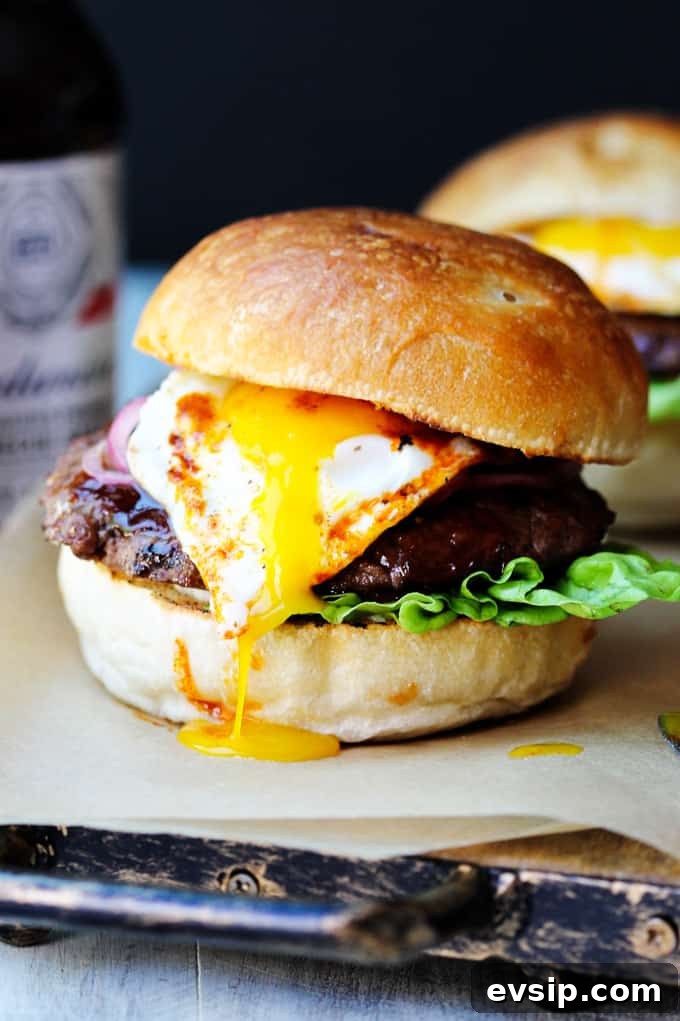Smoky BBQ Burger with Garlic Aioli & Fried Egg Smoky BBQ Burger with runny egg yolk